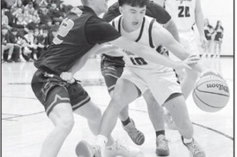 Strother’s Bryce Martin tries to knock the ball away from Konawa’s Triston Lankford. Courtesy Photo by Glen Bryan
