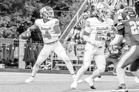 Above: Seminole’s Jay Ladd streaks to the end zone Friday night. Left, Chieftain Timothy McFadden makes a tackle. Below, Seminole QB Donavin Garfield gets ready to let a pass fly downfield. —Photos by Ben Schatzel
