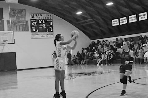 New Lima Falconette Jazzy Harjo shoots one of her many three-point shots Thursday night. Staff Photo by Bill Anderson