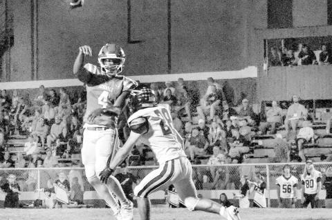 Chieftain QB Donavin Garfield rolls out and completes a pass Friday night against Tecumseh. Courtesy Photo by Ben Schatzel