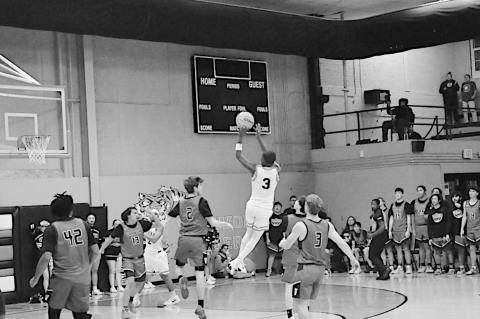 Wewoka Tiger Bill Stephens takes a shot right before the buzzer at the half. Staff Photo by Bill Anderson