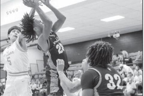 Seminole Chieftain Jay Ladd gets a basket attempt as he gets by a defender. Courtesy Photo by Glen Bryan