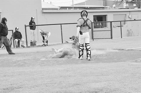 Varnum Whippet Devyn Fullbright slides into home safe Friday. Staff Photo by Bill Anderson