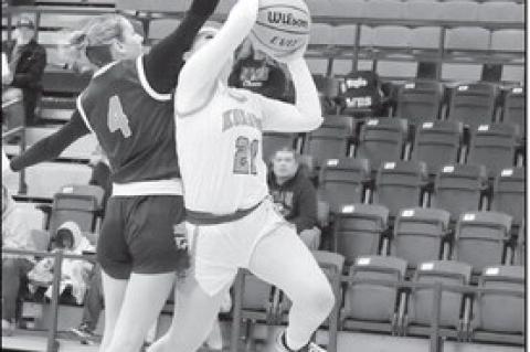 Konawa Lady Tiger Kassidi Lowden tries to get a shot off over a Wilson defender. Courtesy Photo by Glen Bryan