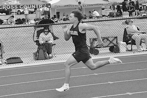 Konawa Tiger Layne Akerman sprints to the finish line in first place in the 100M Friday. Staff Photo by Bill Anderson