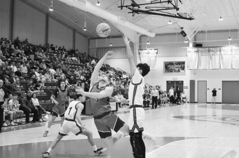 Varnum Whippet Devyn Fullbright maneuvers around his opponent for the basket Friday. Staff Photo by Andy Wilson