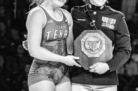 Landri Von Gonten receiving her first-place plaque at the USMC Junior National Wrestling Championships from U.S. Marine Corps Capt. Monique Devitt. (Photo provided)