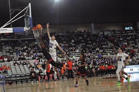 Wewoka Tiger Bill Stephens flies in for the basket Thursday night against Hartshorne. Staff Photo by Bill Anderson