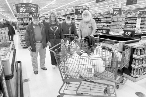 Meal Prep —Courtesy photo American Legion Post 204 donated 20 turkeys to support the Rotary Christmas Dinner. Pictured are American Legion members Harris Thacker, Robert Gatzke and Carl Odom with Angela Willmett, Rotarian and Asst. Superintendent of Sem