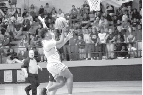 Wewoka Tiger Trae Woods drives in for the basket in last Thursday’s game against the Warner Eagles. Wewoka win the Class 2A, District 4 Championship with a final score of 62-52. (Staff photo by Bill Anderson)