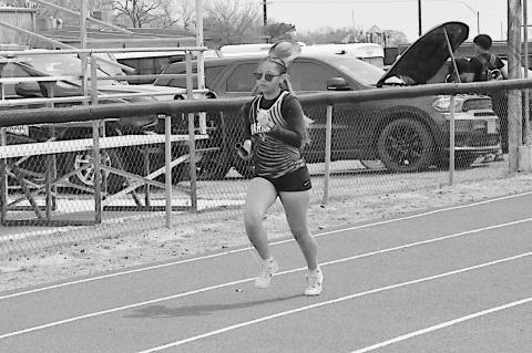 Varnum Lady Whippet Makayla Louie runs the first leg of the 4 X 100 Tuesday. Staff Photo by Bill Anderson