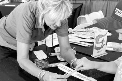 Stephanie Holt-Lucas, Aerospace Education Coordinator for the Oklahoma Department of Aerospace and Aeronautics, helps assemble of balsa wood planes at the STEM City hangar during the 2025 Tinker Air Force Base Warriors of Air and Space air show. (Photo pr