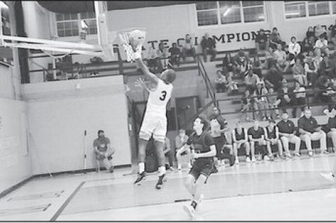 Wewoka Tiger Bill Stephens flies in for the layup Monday night against Vanoss. Wewoka Tigers won 67-60. Staff Photo by Bill Anderson