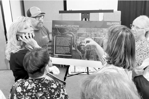Green Country residents speak with an Oklahoma Primary Aluminum employee at a March open house. (Elizabeth Caldwell/Oklahoma Watch)
