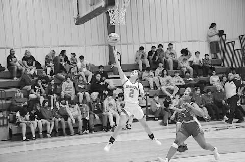 Sasakwa Lady Viking KK Wheeler flies in for the layup just past the Butner Lady Eagle Laniya Walker Friday. Staff Photo by Bill Anderson