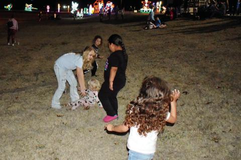 Above, below: It may have been the week of Christmas, but Tuesday night felt more like a warm summer night for those who attended the finale of Snowman Wonderland. Every year, the light display in Magnolia Park attracts thousands of visitors. —Staff Pho