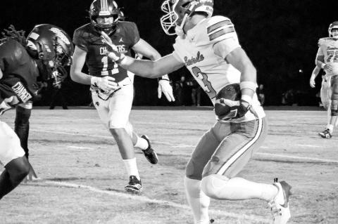 Right, Mason Bennett of the Seminole Chieftains goes for the stiff arm against his opponent Friday night in the first round of the playoffs. The #1 seed Heritage Hall defeated the #4 seed Chieftains, capitalizing on five Seminole turnovers for a 52-34 win