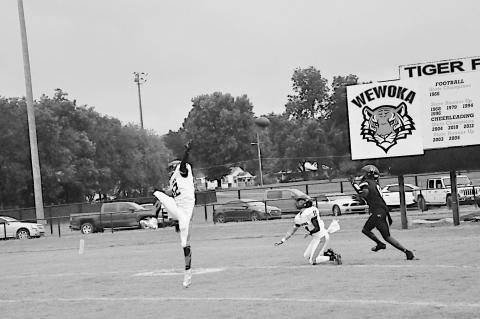 Staff Photo by Bill Anderson Konawa Tiger Layne Akerman tips the ball into the hands of Wewoka Tiger Bill Stephens for the touchdown Friday.