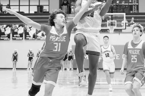 Seminole Chieftain Jay Ladd beats a Prague defender to the basket Thursday Night. Courtesy Photo by Glen Bryan