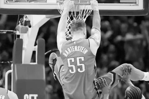 Seminole Chieftain Kenneth Johnson tries the hook shot to avoid defender. Staff Photo by Andy Wilson