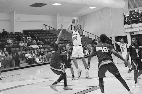 Seminole State Trojan Jamarri Simpson makes the jump shot over the Western Oklahoma State College defender Monday night. Staff Photo by Bill Anderson