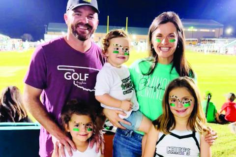 Above, Tyler Geohagan with his wife, Dr. Jenna Geohagan and children, Nora, Maya and Ella at a Seminole Chieftain football game. Tyler has announced his candidacy for the soon to be open seat on the Seminole Public Schools Board of Education. The election
