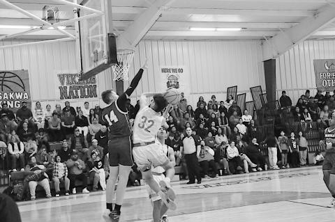 Sasakwa Viking Josh Jones flies in for the shot as the Weleetka defender tries to block Friday night. Sasakwa won 85-35. Staff Photo by Bill Anderson