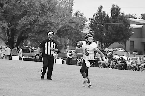 Strother Yellowjacket quarterback Mylam Defries scrambles to find an open receiver. Staff Photo by Andy Wilson