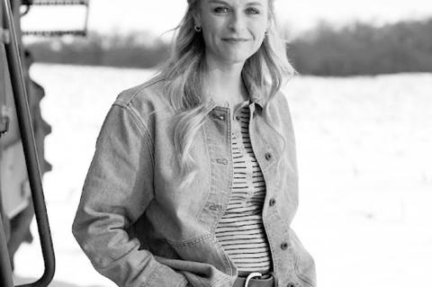 Altus cotton farmer Charlcey Plummer poses with her combines on Jan. 28, 2025. (Brent Fuchs/Oklahoma Watch)