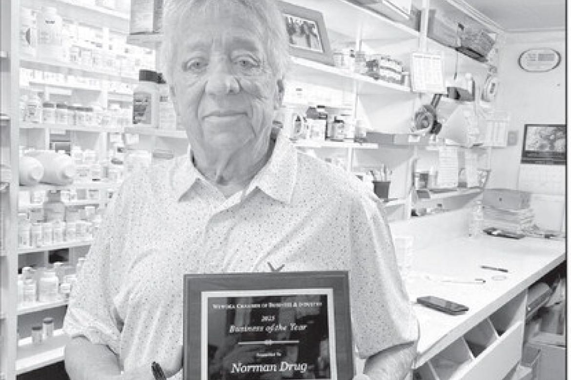 John Norman of Norman Drug in Wewoka holds the plaque he was presented with by the Wewoka Chamber of Business &amp; Industry for 100 years of service to the community. The award was presented at the Chamber’s banquet on March 30. (Courtesy photo)
