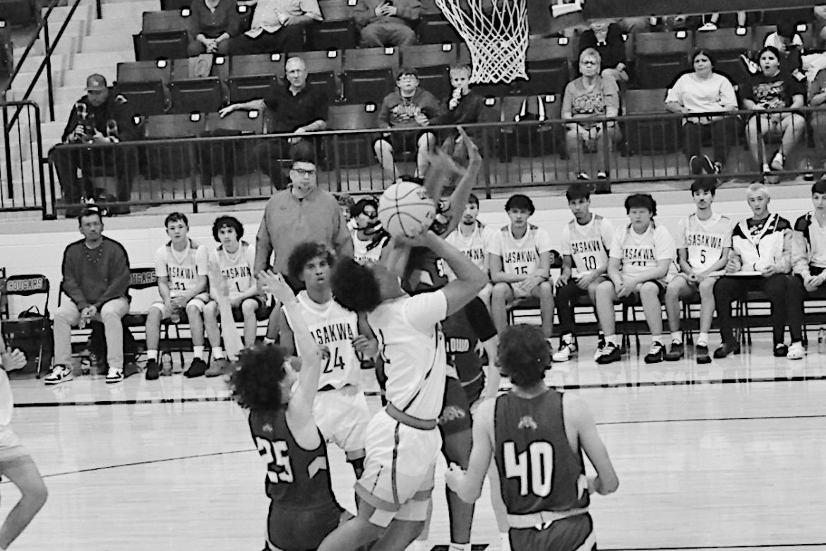Sasakwa Viking Sherman Mitchell goes in between two defenders for the basket Thursday. Staff Photo by Bill Anderson