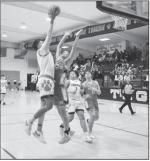 Maud Tiger Treat Marshall goes up and over his defender for the basket. Staff Photo by Andy Wilson