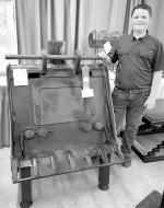 Cooper and his 2025 agricultural mechanics project, a wood-burning stove crafted from an old backhoe bucket, which earned him a blue ribbon at the Oklahoma Youth Exposition, grand champion at the Love County Fair and first place at the Oklahoma State Fair