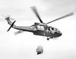 An Oklahoma Army National Guard UH-60 Black Hawk flies over the 702 Fire in Blaine County, Oklahoma after dropping more than 600 gallons of water on the fire, July 16, 2022. The Oklahoma National Guard is supporting the Oklahoma Forestry Services and loca